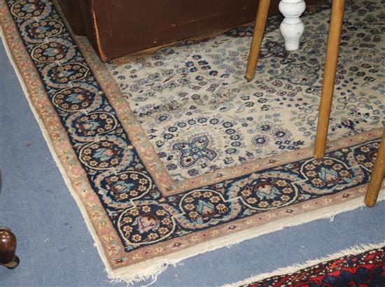 A Persian cream and blue ground rug 212cm x 137cm